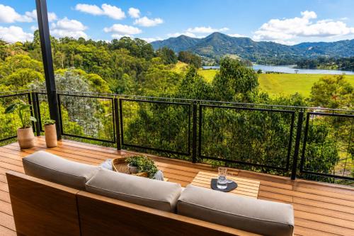 a balcony with couches and a view of the mountains at Verso el Retiro in El Retiro