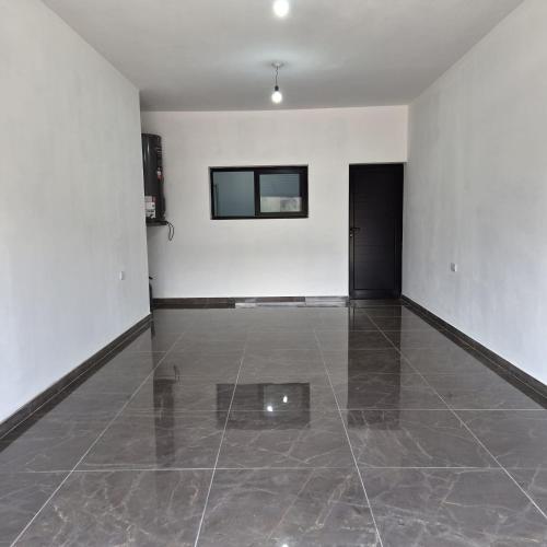 an empty room with a tiled floor and white walls at Departamento LUNA DE BELEN in Belén