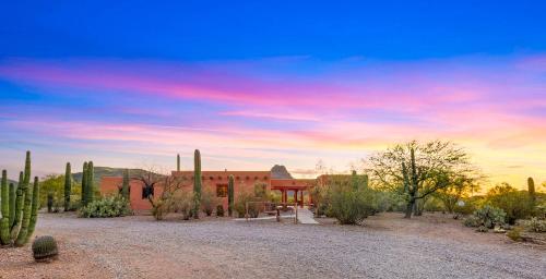 a building in the middle of a desert with cactus at Cereus Vista in Tucson