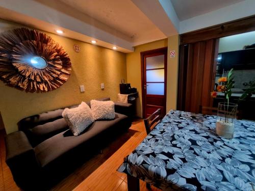a living room with a couch and a mirror at Villa Lainez in Villa Mercedes