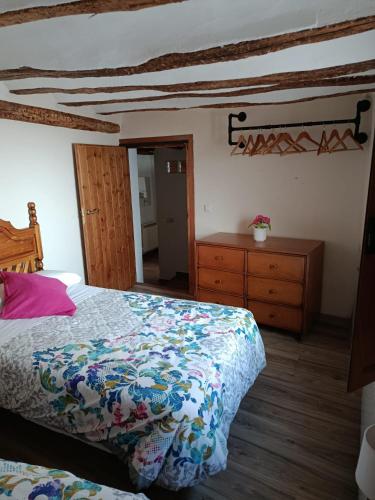 a bedroom with a bed and a dresser at La calma de Arnedillo in Arnedillo