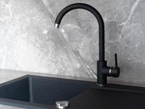 a kitchen sink with a faucet on a counter at Murleben Top 06 in Stadl an der Mur