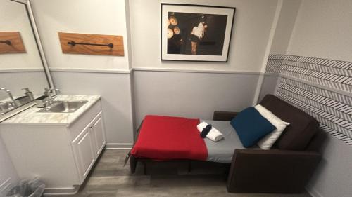 a small bathroom with a sink and a chair at Stay Chicago in Chicago
