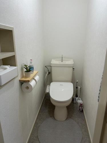 a bathroom with a white toilet in a room at Guest House "Ro"Hieda B101 in Shimonoseki