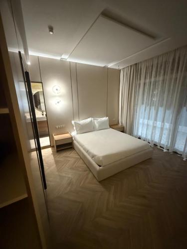 a bedroom with a white bed and a window at Villa élite in Tangier