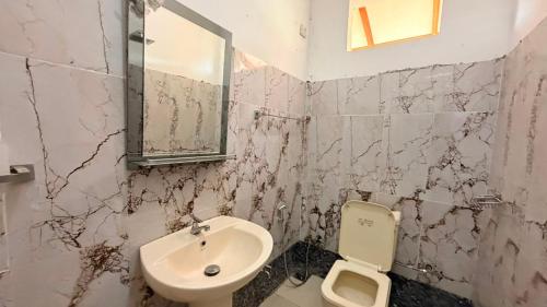 a bathroom with a sink and a toilet at Blissful Chateau in Batigama