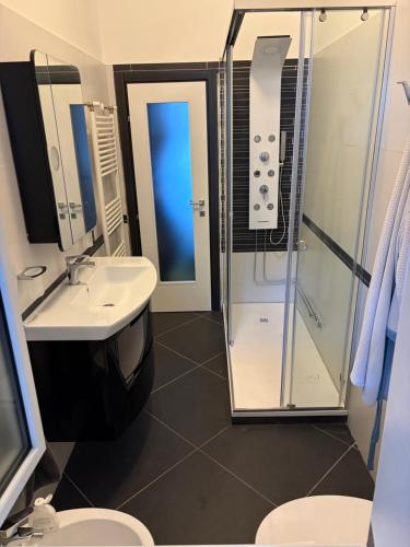 a bathroom with a sink and a shower and a toilet at Casa Giulia in Taviano