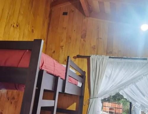 a bedroom with a bunk bed and a window at Hospedaje Francesco in Puerto Montt