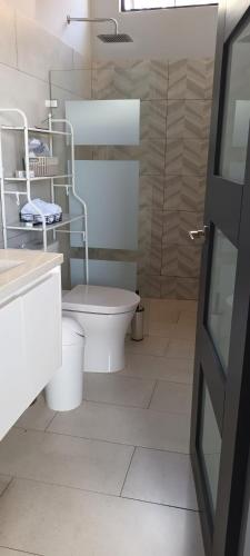 a bathroom with a toilet and a sink at Cacique Room 2 in Playa Hermosa