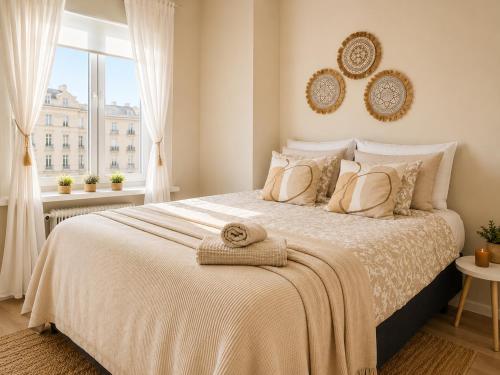 a bedroom with a large bed and a window at GuestFirst- Modern Boho Charm in Kallio Helsinki Center in Helsinki