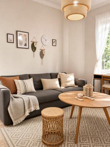 a living room with a couch and a table at GuestFirst- Modern Boho Charm in Kallio Helsinki Center in Helsinki