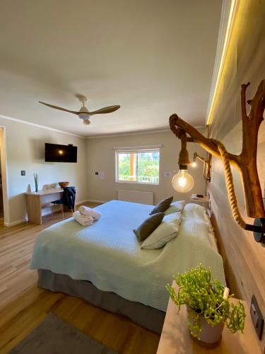 a bedroom with a large bed and a table with plants at EcoHotel El Almendro in Paine