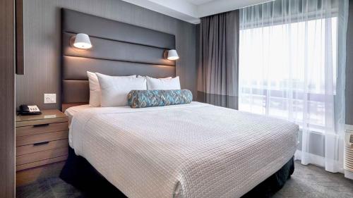 a bedroom with a large bed and a window at Zemira Apartments in Abuja