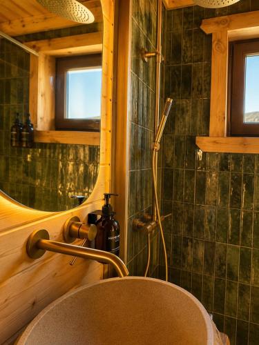 a bathroom with a sink and a mirror at Chalé Recanto 39 Luxury Mountain Retreat in Penhas da Saúde