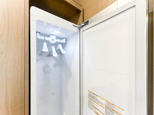 a glass shower door with a mannequin in it at 군산 비욘드 호텔 in Sinp'ung