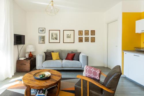 a living room with a couch and a table at Romantic Pier by Rent All Como in Carate Urio