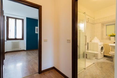 a bathroom with a shower and a sink and a toilet at Family Lake Apartment by Rent All Como in Mezzegra