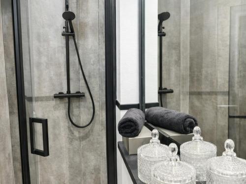 a bathroom with a shower with a mirror and towels at The Jade Elegant apartment with balcony in Spa
