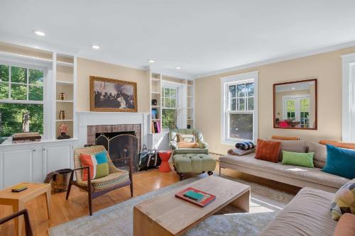 a living room with a couch and a fireplace at Classic Stockbridge Cottage in Stockbridge