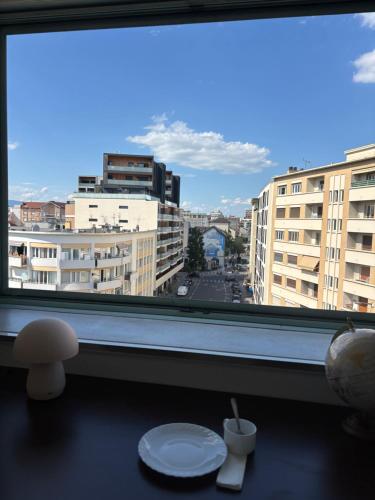 a window with a view of a city with buildings at L'escapade in Annemasse