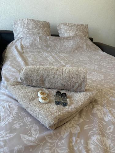a bed with two shoes and a towel on it at L'escapade in Annemasse