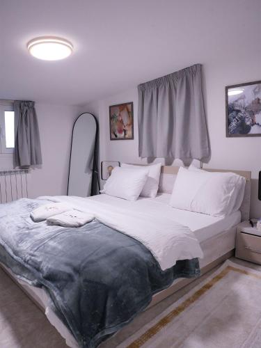 a bedroom with a large bed with white sheets and pillows at Casa Dunia - 2 BR Open Sea View Apartment in Sahl ‘Almā