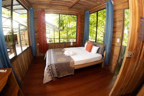 a bedroom with a bed in a room with windows at Terrazas del Golfo in La Palma