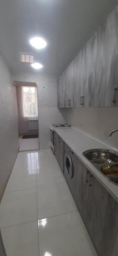 a kitchen with a sink and a washing machine at Гостевой дом in Sevan