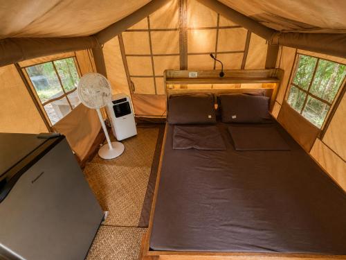 an overhead view of a tent with a bed and a fan at Soffta Surf Ranch in General Luna