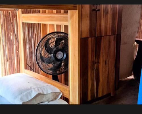 a bedroom with a bed with a wooden wall at Bob Marley Beach in Guachaca