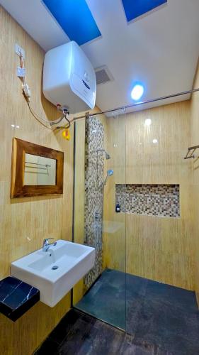 a bathroom with a sink and a shower at Omah Tabon Homestay Heritage Stay near Malioboro in Yogyakarta