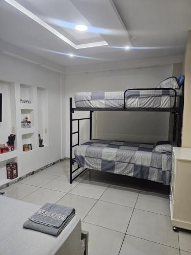 a room with two bunk beds and a table at Newly Opened Mini Suite in Manta