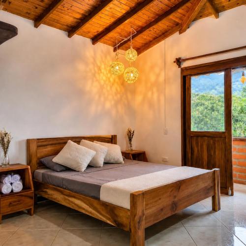 a bedroom with a wooden bed in a room at Hotel Campestre Alameda in Támesis