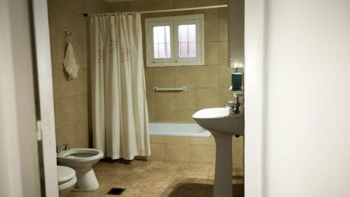 a bathroom with a sink and a toilet and a shower at "Alojamiento en Uspallata" para hasta 6 personas in Uspallata