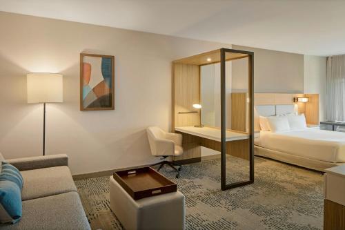 a hotel room with a bed and a couch at SpringHill Suites by Marriott High Point Downtown in High Point