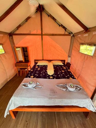 a bedroom in a tent with a bed in it at Beach Camp Lombok in Sekotong