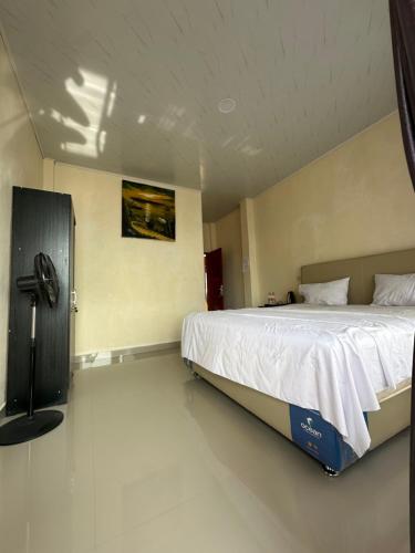 a bedroom with a large bed in a room at Maruba inn in Tuktuk Siadong