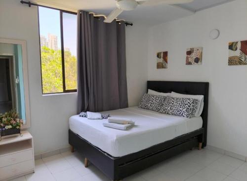 a bedroom with a large bed with a window at Villa Hercilia - Rodadero in Rodadero