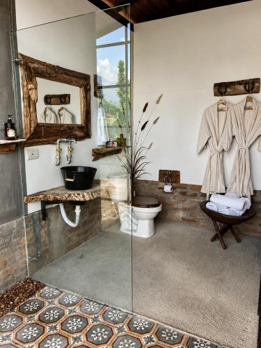 a bathroom with a glass shower and a toilet at El Caney Experiences in Armenia