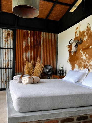 a bedroom with a bed with a skull on the wall at El Caney Experiences in Armenia