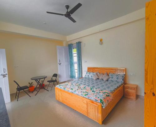 a bedroom with a wooden bed and a ceiling fan at Cedar Crest Homestay in Kulu