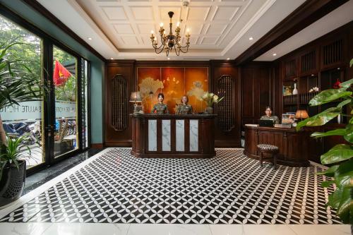 a lobby with a reception desk in a building at Salute Premium Hotel & Spa in Hanoi