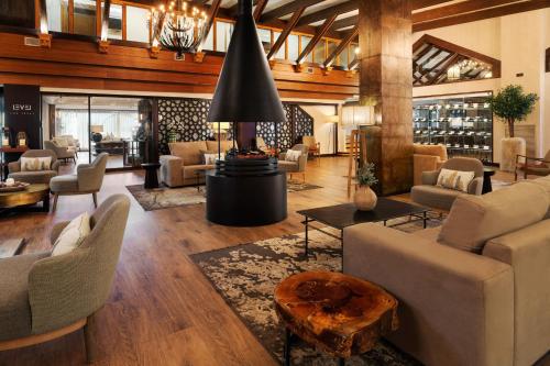 a living room with couches and chairs and a table at Meliá Sierra Nevada in Sierra Nevada