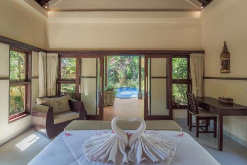 a bedroom with a bed with a swan decoration on it at Villa KaRo Pemuteran in Pemuteran