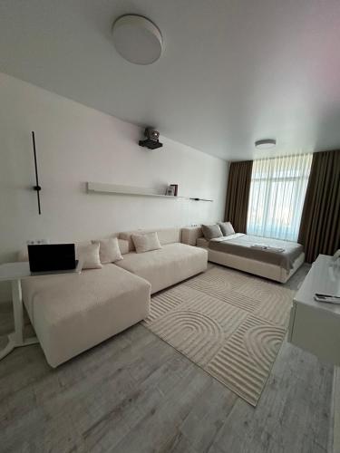 a living room with two white couches and a rug at Bila Perlyna - Люкс, пляж, паркінг, укриття in Odesa