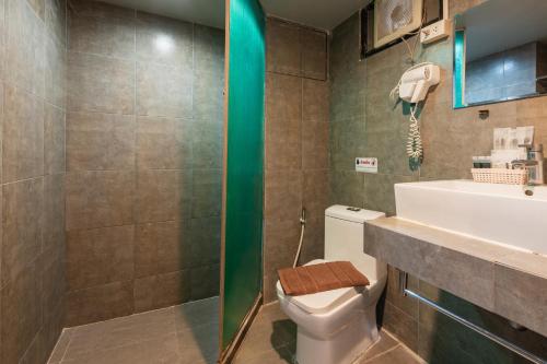 a bathroom with a toilet and a sink and a shower at BKK39 Airport Hotel in Lat Krabang