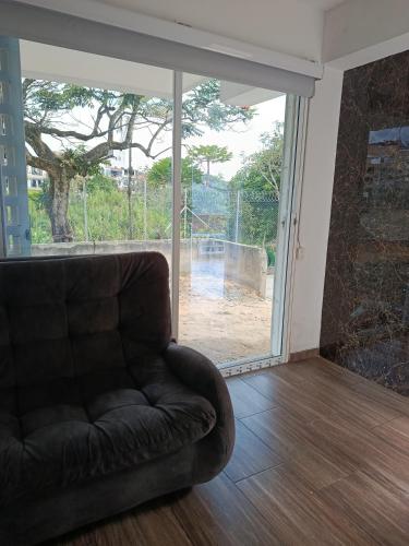 a living room with a couch and a sliding glass door at Casa de alejo in Pereira
