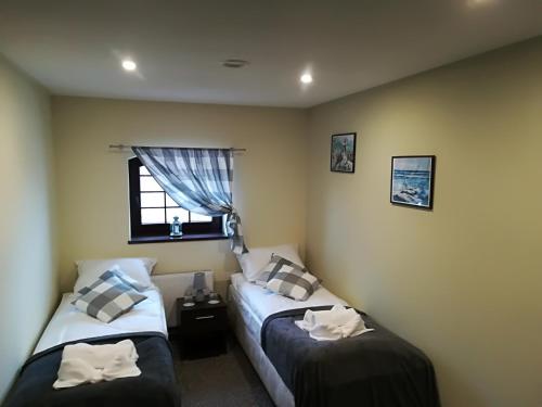 a bedroom with two beds and a window at Młyn in Chodecz
