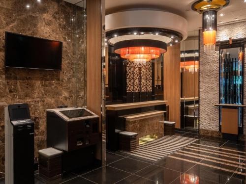 a lobby of a hotel with a tv and a lobby at APA Hotel Ueno Ekikita in Tokyo