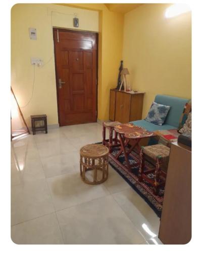 a living room with a couch and a table at Sir Residency in Howrah